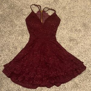 This is a formal or homecoming dress. It's a dark maroon with glitter.